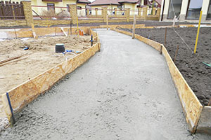Building new concrete pavement foundation in the garden. Foundation for paving, path, walkway.